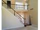 Elegant foyer with a wood and white staircase and dark hardwood flooring, offering a bright entry at 533 Mount Gerizim Se Rd, Mableton, GA 30126