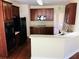 Well-equipped kitchen with dark wooden cabinets, stainless steel appliances, and a breakfast bar at 533 Mount Gerizim Se Rd, Mableton, GA 30126
