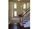Spacious living room with a fireplace, tall ceilings, and a staircase with white railings at 533 Mount Gerizim Se Rd, Mableton, GA 30126