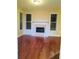 A spacious living room with a fireplace and large windows and hardwood flooring at 533 Mount Gerizim Se Rd, Mableton, GA 30126
