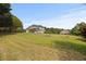 Expansive backyard with a sprawling lawn and patio area, great for outdoor activities at 5604 Mccullers Ln, Loganville, GA 30052