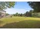 Large backyard with lush green grass and mature trees, perfect for relaxation and recreation at 5604 Mccullers Ln, Loganville, GA 30052