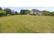 Spacious backyard with a well-kept lawn and mature trees, offering privacy at 5604 Mccullers Ln, Loganville, GA 30052