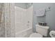 Bathroom with tub and shower, seashell shower curtain, toilet, towel rack and light blue walls at 5604 Mccullers Ln, Loganville, GA 30052