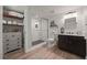 Bathroom with a glass enclosed shower, vanity, and shelving, plus wood look floors at 5604 Mccullers Ln, Loganville, GA 30052