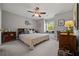 Bedroom with cozy window seat, comfortable bed, ceiling fan, and decorative accents at 5604 Mccullers Ln, Loganville, GA 30052