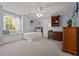 Bedroom with a bed, window bench, built in shelving, carpeted floor and light blue walls at 5604 Mccullers Ln, Loganville, GA 30052