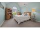 Bedroom boasting a pitched ceiling, white bedding, wooden furniture, and a bright window at 5604 Mccullers Ln, Loganville, GA 30052