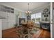 Cozy dining area with fireplace, light fixture, large window, and hardwood floors at 5604 Mccullers Ln, Loganville, GA 30052