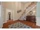 Grand foyer featuring hardwood floors and an elegant staircase, offering a warm and inviting entrance at 5604 Mccullers Ln, Loganville, GA 30052
