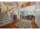 Spacious foyer featuring hardwood floors, an elegant staircase, and an open view to the dining area at 5604 Mccullers Ln, Loganville, GA 30052
