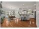 Bright kitchen with an eat-in dining area, white cabinetry, and a functional island with bar seating at 5604 Mccullers Ln, Loganville, GA 30052