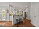 Bright kitchen features white cabinets, stainless steel appliances, granite countertops and hardwood floors at 5604 Mccullers Ln, Loganville, GA 30052