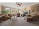 Inviting living room with a fireplace, comfortable seating, and large windows, creating a cozy atmosphere at 5604 Mccullers Ln, Loganville, GA 30052