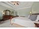 Spacious main bedroom with tray ceiling and hardwood furnishings at 5604 Mccullers Ln, Loganville, GA 30052