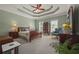 Spacious main bedroom with tray ceiling, hardwood furnishings, and ample natural light at 5604 Mccullers Ln, Loganville, GA 30052