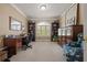 Home office with built-in bookshelves, a cozy chair, and natural light, creating an ideal work space at 5604 Mccullers Ln, Loganville, GA 30052