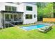 A modern backyard featuring a pool and a patio on a two-story home, perfect for relaxing and entertaining at 820 Moores Mill Nw Rd, Atlanta, GA 30327