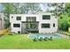 A modern white home with a beautiful backyard including a pool and plenty of green space at 820 Moores Mill Nw Rd, Atlanta, GA 30327