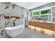 Serene bathroom with a freestanding tub, marble accents, wood vanity, and modern fixtures at 820 Moores Mill Nw Rd, Atlanta, GA 30327