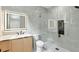 Modern bathroom with a frameless glass shower, floating vanity, and tiled accent wall at 820 Moores Mill Nw Rd, Atlanta, GA 30327