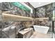 Luxury bathroom featuring a soaking tub, marble accents, a large window, and modern fixtures at 820 Moores Mill Nw Rd, Atlanta, GA 30327