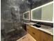 Bathroom with marble tile, backlit mirror and granite countertop with a black vessel sink at 820 Moores Mill Nw Rd, Atlanta, GA 30327