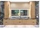 Luxurious bathroom featuring dual sinks, sleek cabinetry, a large illuminated mirror, and marble accents at 820 Moores Mill Nw Rd, Atlanta, GA 30327