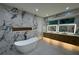 Bright bathroom featuring marble walls, a soaking tub, dual vanities and lighted mirrors at 820 Moores Mill Nw Rd, Atlanta, GA 30327