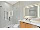 Modern bathroom with a frameless glass shower, floating vanity, and tiled accent wall at 820 Moores Mill Nw Rd, Atlanta, GA 30327