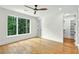 Bright bedroom with hardwood floors, ceiling fan, and large window with a wood view at 820 Moores Mill Nw Rd, Atlanta, GA 30327