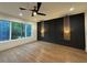 Spacious bedroom featuring hardwood floors, modern ceiling fan, and paneled accent wall at 820 Moores Mill Nw Rd, Atlanta, GA 30327