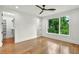Bright bedroom with hardwood floors, ceiling fan, and large window with a wood view at 820 Moores Mill Nw Rd, Atlanta, GA 30327