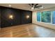 Bedroom featuring hardwood floors, designer lighting and geometrically paneled accent wall at 820 Moores Mill Nw Rd, Atlanta, GA 30327