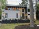 Stunning modern home featuring a tiered front yard and exterior lighting at 820 Moores Mill Nw Rd, Atlanta, GA 30327