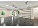 Spacious two-car garage with painted floor, overhead lighting, and automatic doors at 820 Moores Mill Nw Rd, Atlanta, GA 30327