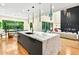 Open-concept kitchen boasts a marble island, hardwood floors, and seamless flow into living spaces at 820 Moores Mill Nw Rd, Atlanta, GA 30327