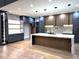 Modern kitchen boasts marble counters and backsplash with a large island at 820 Moores Mill Nw Rd, Atlanta, GA 30327