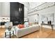 Spacious living room with a black fireplace, stylish decor, and hardwood floors at 820 Moores Mill Nw Rd, Atlanta, GA 30327