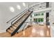 Bright living room featuring open stairs to above with oversized window at 820 Moores Mill Nw Rd, Atlanta, GA 30327