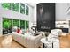 Open-concept living room with a large window, plush sofa, and modern decor at 820 Moores Mill Nw Rd, Atlanta, GA 30327