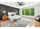Stylish main bedroom featuring an accent wall, large windows, and hardwood floors at 820 Moores Mill Nw Rd, Atlanta, GA 30327