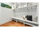 Cozy mudroom features custom built-ins with shelving, hooks, bench seating and modern pillows at 820 Moores Mill Nw Rd, Atlanta, GA 30327