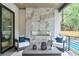Relaxing outdoor patio featuring a fireplace, comfortable seating, and a view of the pool at 820 Moores Mill Nw Rd, Atlanta, GA 30327