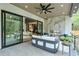 Covered outdoor patio with fireplace, ceiling fan, and seamless transition to indoor living spaces at 820 Moores Mill Nw Rd, Atlanta, GA 30327