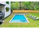 The rectangular backyard pool features a spa and is surrounded by green grass and lounge chairs at 820 Moores Mill Nw Rd, Atlanta, GA 30327