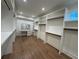 Spacious walk-in closet with custom shelving, drawers, rods, and a vanity area for organized storage at 820 Moores Mill Nw Rd, Atlanta, GA 30327
