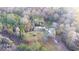 A tranquil aerial view showcasing the home nestled amidst a lush forest backdrop and expansive lot at 98 Almon Church Rd, Covington, GA 30014