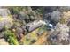 Aerial view of a house surrounded by trees and a large yard at 98 Almon Church Rd, Covington, GA 30014