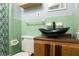 A bathroom featuring wood vanity, unique sink, wood shelves, updated light fixture, and tiled walls at 98 Almon Church Rd, Covington, GA 30014